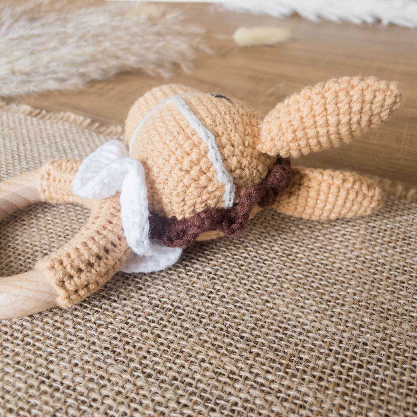 dettaglio del retro del sonaglio amigurumi a forma di cavallo color marrone, bianco con criniera marrone scuro